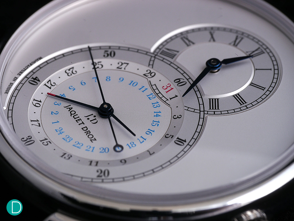 The Grande Seconde Dual time dial. The upper dial shows local time and uses roman numerals. The lower, larger dial shows the reference time, which can be set to home time or GMT or any other time, and also concentric with the seconds hands and a date hand.