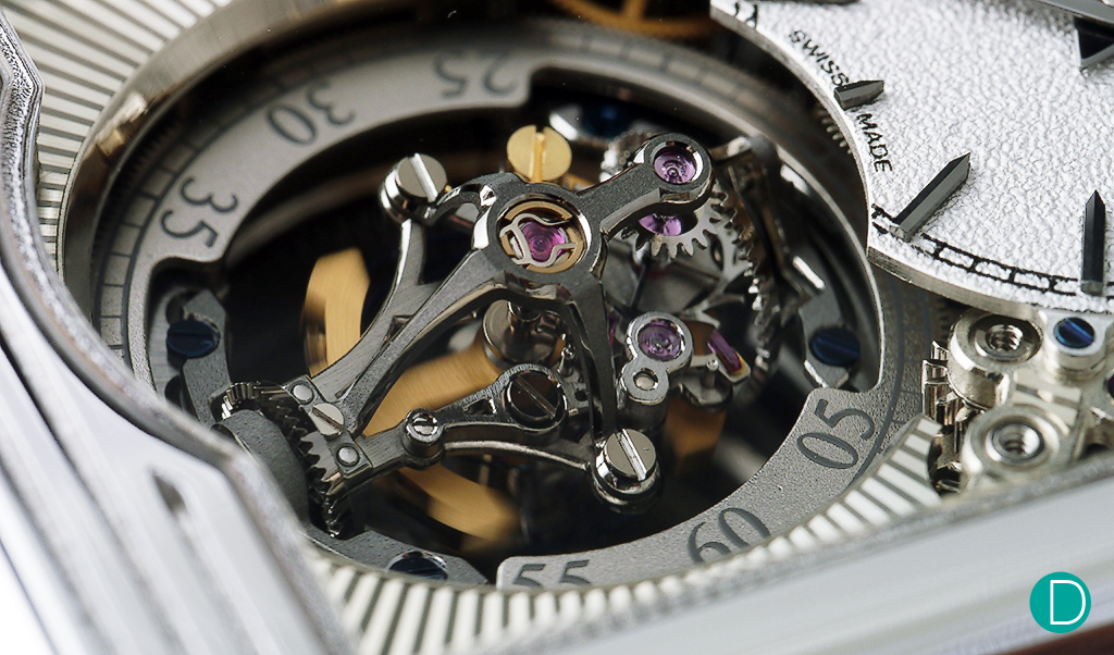 Another view of the tourbillon. In this view, the hairspring is not visible as it is only present on the other side of the balance wheel, but the drive mechanism of the dual axis is visible. 