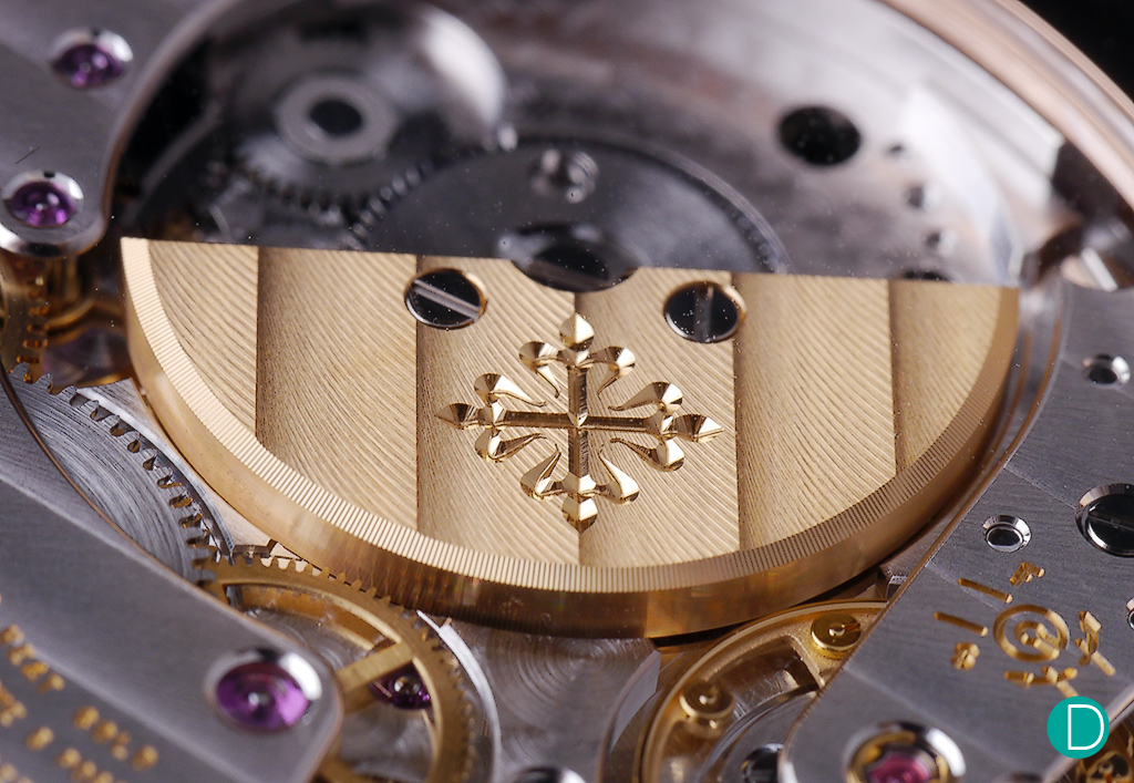 The rotor, bearing an engraving of the Calatrava Cross which Patek Philippe uses as a logo. 