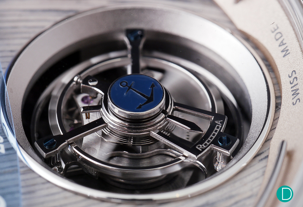 The tourbillon is quite standard. The decoration on the top of the endstone is a blue UN anchor. 